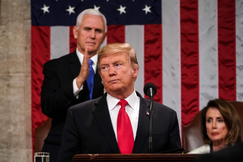 US President Donald Trump delivers the State of the Union address, alongside Vice President Mike Pence and Speaker of the House Nancy Pelosi, at the US Capitol in Washington, DC, on February 5, 2019. AFP / POOL / Doug Mills