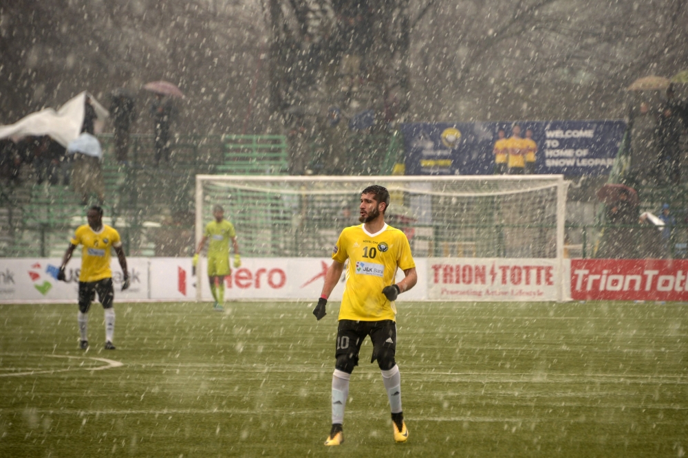 In this photo taken on February 6, 2019, Real Kashmir's Danish Farooq looks on amid snowfall during their I-League club football match against Gokulam Kerala FC at the Tourist Reception Centre football ground in Srinagar. / AFP / Tauseef MUSTAFA 