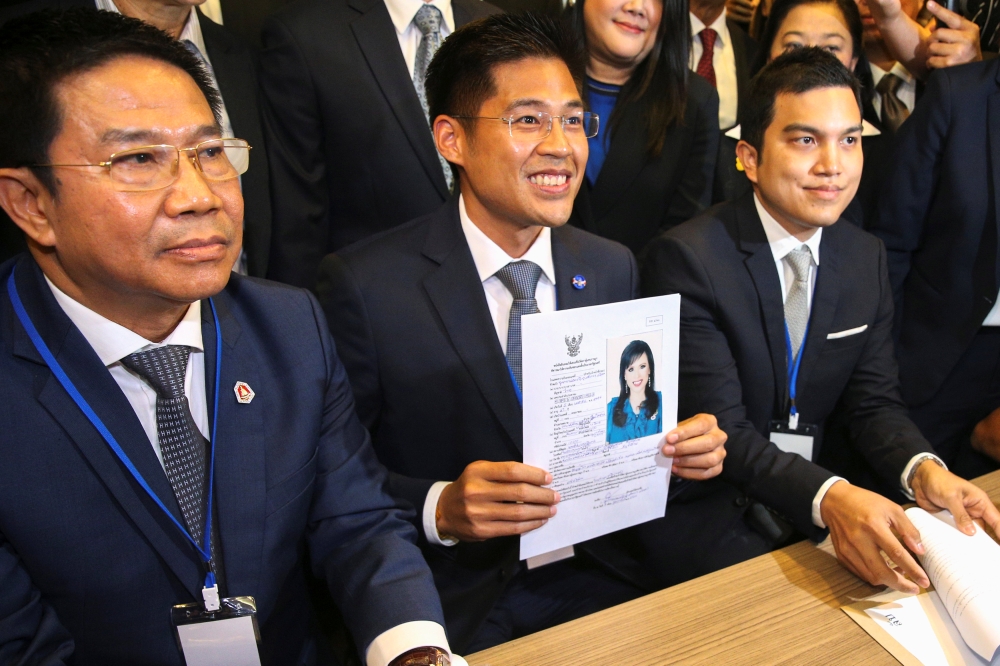 Thai Raksa Chart party leader Preechapol Pongpanich, holds up application of candidate for Prime Minister, Thailand's Princess Ubolratana Rajakanya Sirivadhana Barnavadi, at the election commission office in Bangkok, February 8, 2019. Reuters/Athit Perawo