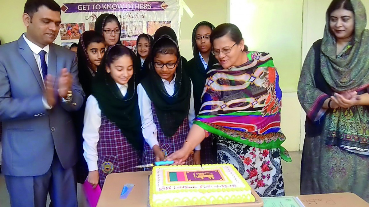 Nargis Raza Otho, Principal of PISQ, cutting a cake to celebrate the Independence Day of Sri Lanka. 
