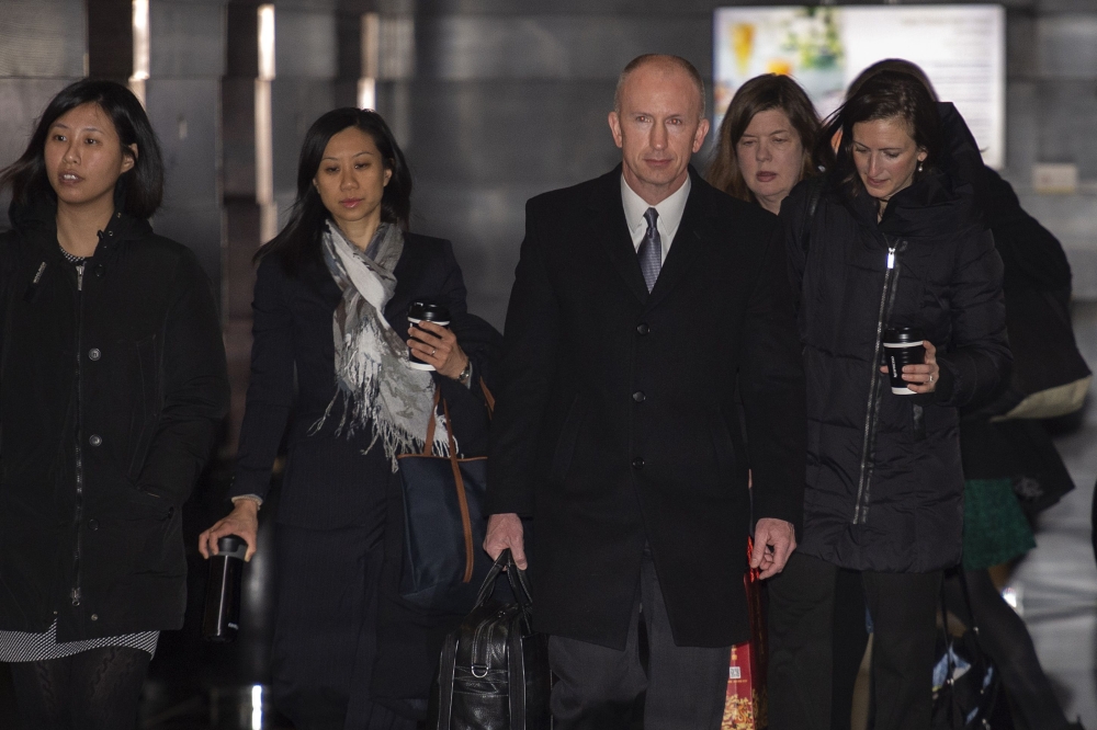 US Deputy Trade Representative Jeffrey Gerrish (C) and members of his negotiation team leave a hotel ahead of a meeting with Chinese officials in Beijing on February 11, 2019. / AFP / NICOLAS ASFOURI 