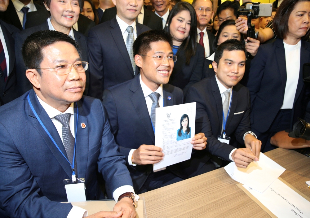 File photo of Thai Raksa Chart party leader Preechapol Pongpanich, holds up application of candidate for Prime Minister, Thailand's Princess Ubolratana Rajakanya Sirivadhana Barnavadi, at the election commission office in Bangkok, Thailand February 8, 201
