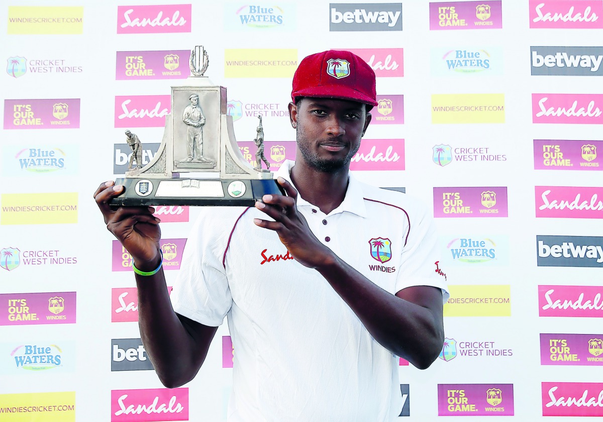Jason Holder celebrates with the Wisden Trophy after the match Action Images via Reuters/Paul Childs 
