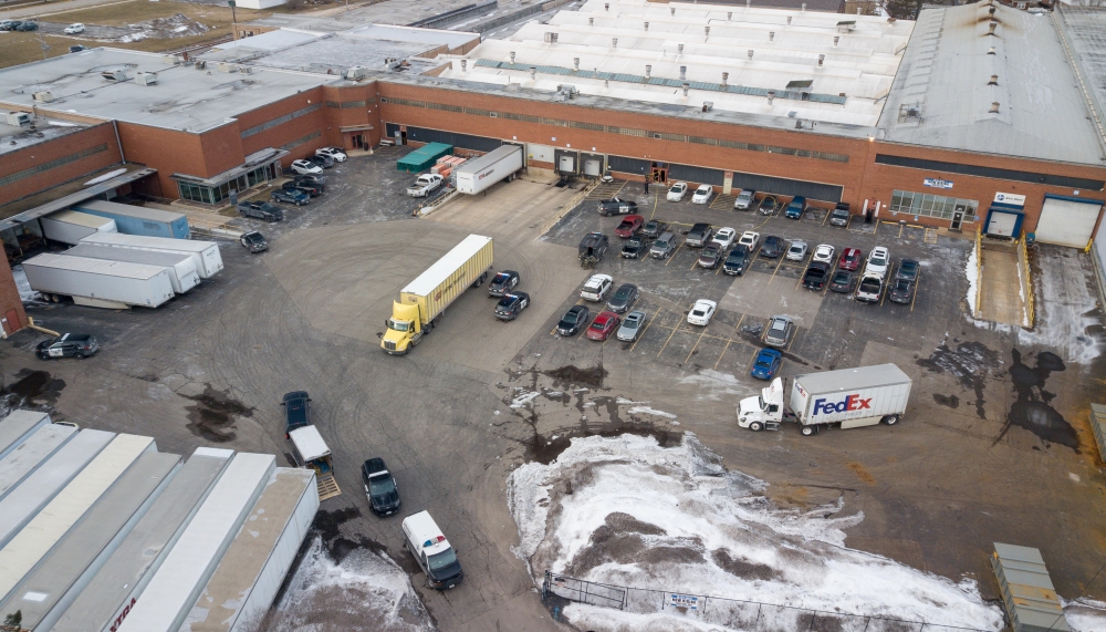 An aerial photo of police and emergency vehicles parked in a lot adjacent to a warehouse at the scene of a mass shooting involving multiply casualties in Aurora, Illinois, U.S., February 15, 2019. Bev Horne/Daily Herald/via REUTERS
