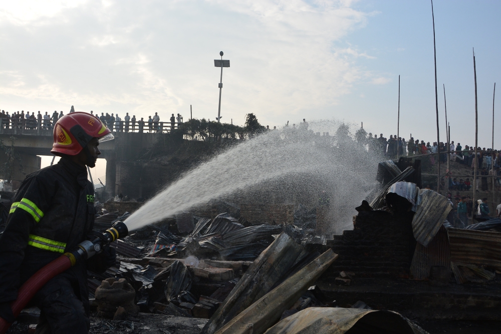 A firefighter works to extinguish fire at a slum where at least eight people killed in Chittagong, Bangladesh February 17, 2019. REUTERS/Stringer 