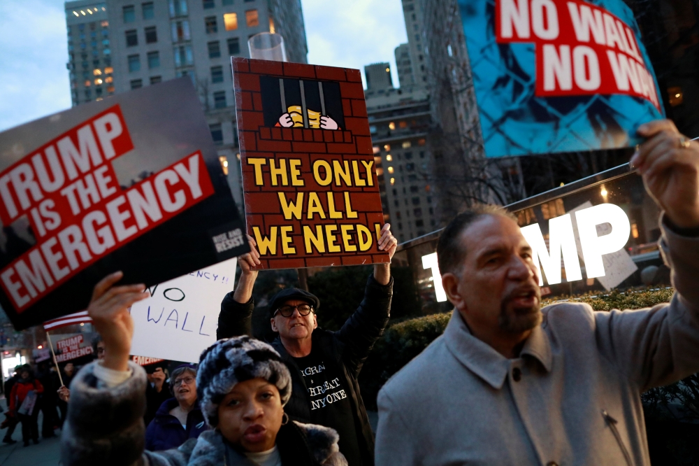 People gather to protest against U.S. President Donald Trump's declaration of a national emergency to build a border wall, at Trump International Hotel & Tower in Manhattan, New York, U.S. February 15, 2019. REUTERS/Andrew Kelly