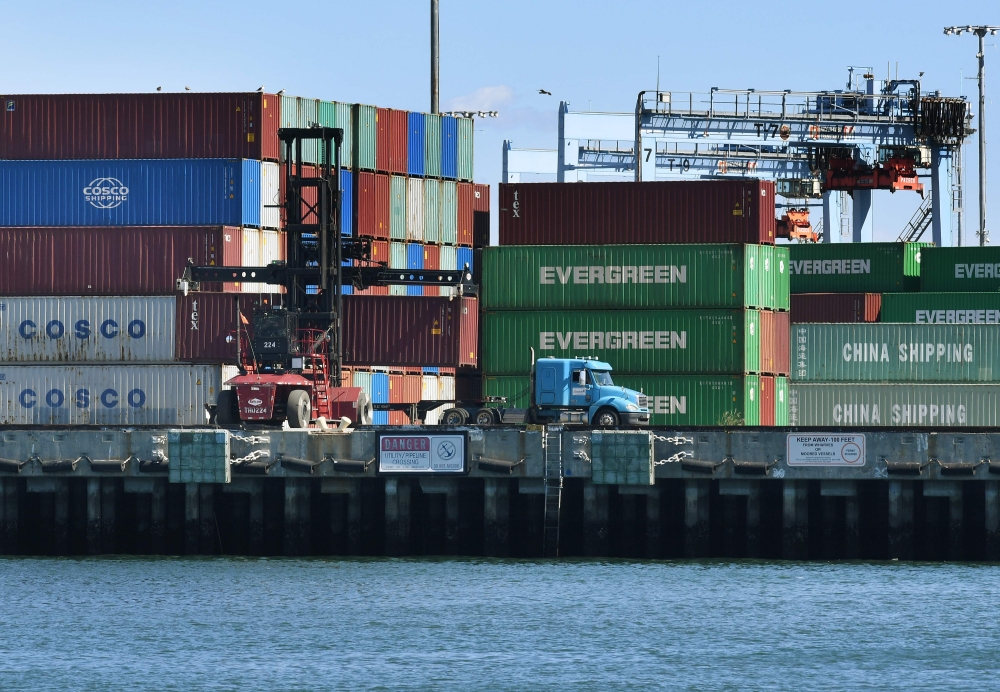 (FILES) In this file photo taken on February 16, 2019, shipping containers from China and other nations are unloaded at the Long Beach Port in Los Angeles, California. AFP / Mark Ralston 