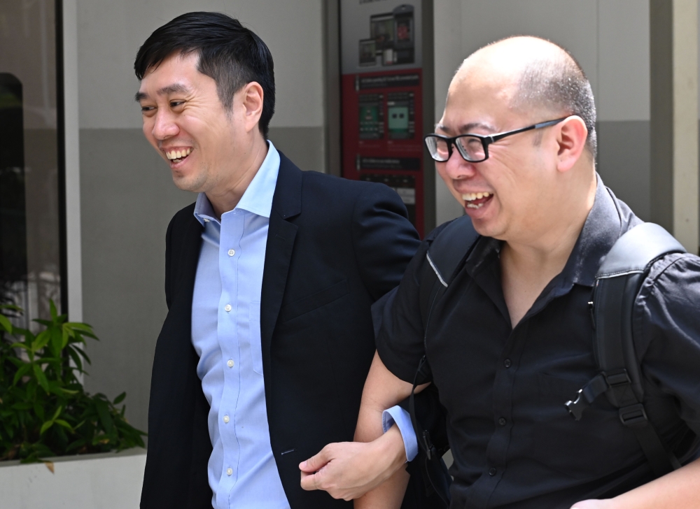 Singaporean activist Jolovan Wham (L) arrives at the State Court in Singapore on February 21, 2019 to face sentence for organising alleged illegal protest. / AFP / Roslan RAHMAN