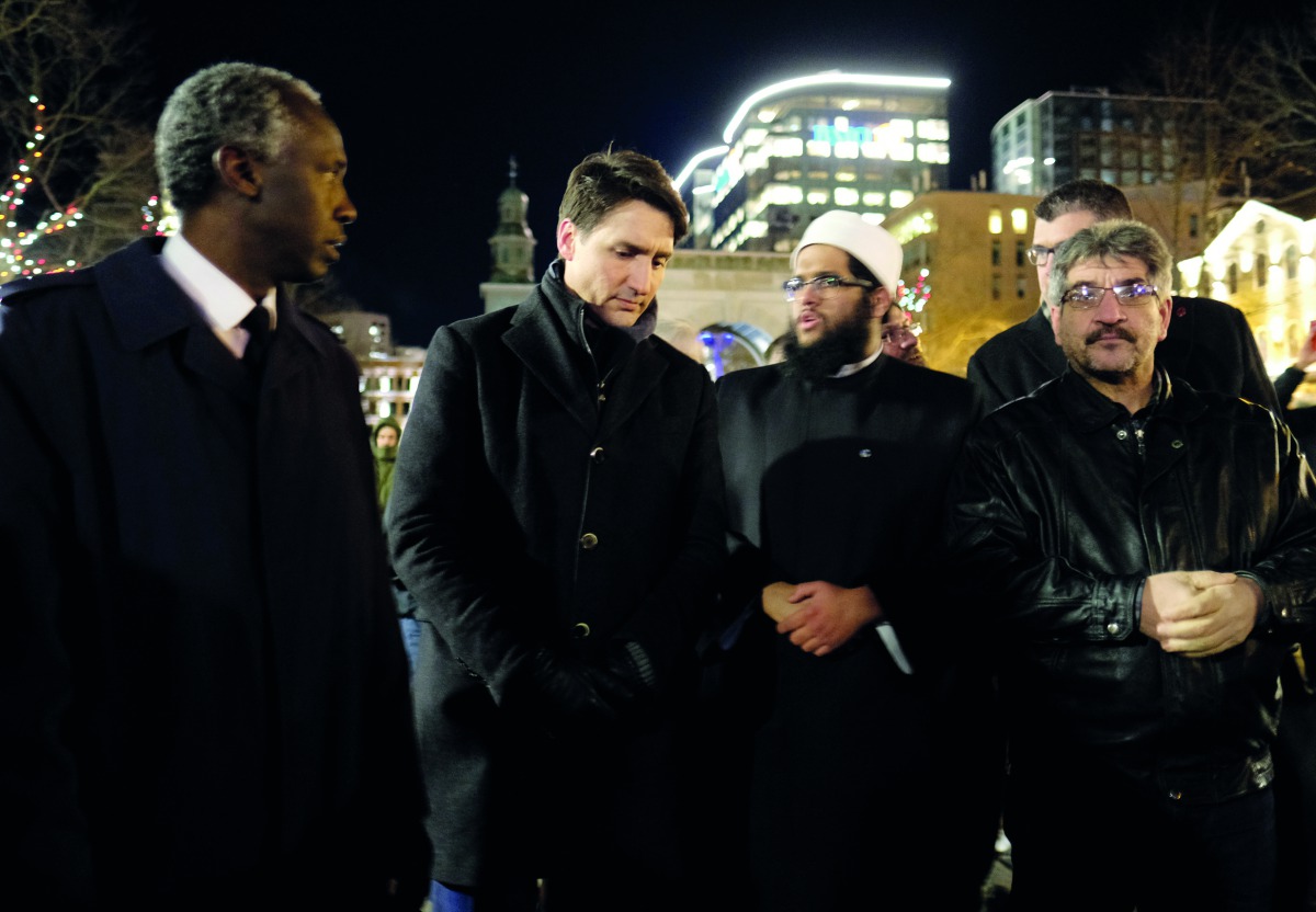 Canada's Prime Minister Justin Trudeau speaks with members of the Nova Scotia Muslim community while in attendance for a vigil in support of a Syrian refugee family who lost seven children killed in a house fire in the community of Spryfield earlier in th