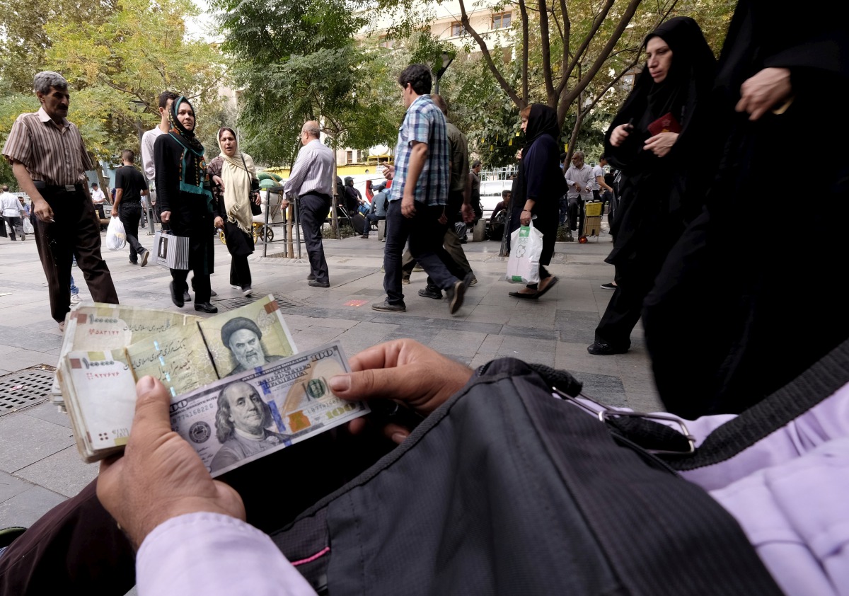 A money changer displays US and Iranian banknotes at the Grand Bazaar in central Tehran, October 7, 2015. Reuters/Raheb Homavandi