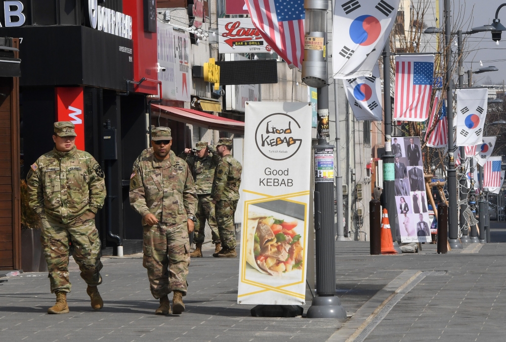 This picture taken on February 21, 2019 shows US soldiers walking at a shopping zone outside the US Camp Humphreys in Pyeongtaek. AFP / Jung Yeon-je 