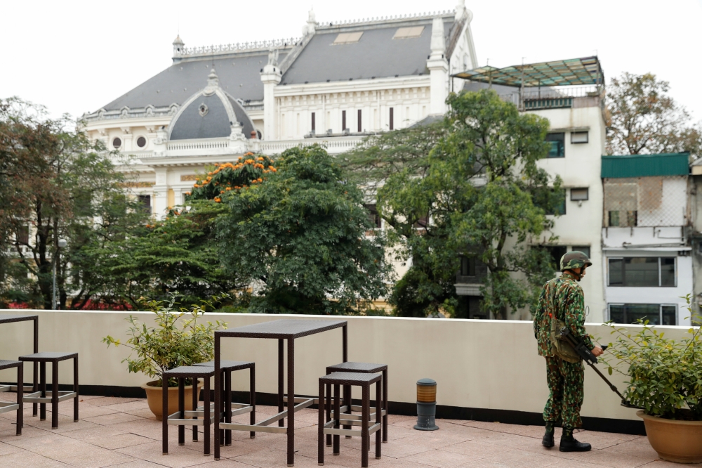 A Vietnamese soldier uses a metal detector at a Hilton hotel's terrace, next to the Opera building, ahead of the North Korea-U.S. summit in Hanoi, Vietnam, February 24, 2019. REUTERS/Jorge Silva
