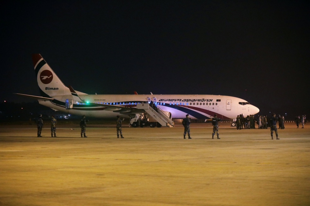 Security personnel stand guard outside of the hijacked aircraft of the Biman Bangladesh Airlines in the Shah Amanat International Airport in Chattogram, Bangladesh February 24, 2019. REUTERS/Stringer