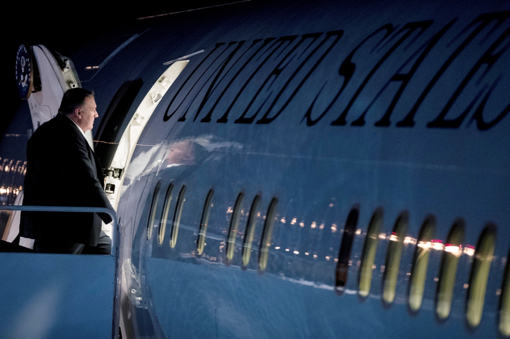 Secretary of State Mike Pompeo boards a plane at Andrews Air Force Base, Md. Sunday, Feb. 24, 2019, to travel to Hanoi, Vietnam, ahead of a planned second summit between President Donald Trump and North Korean leader Kim Jong Un. Andrew Harnik/Pool via Re