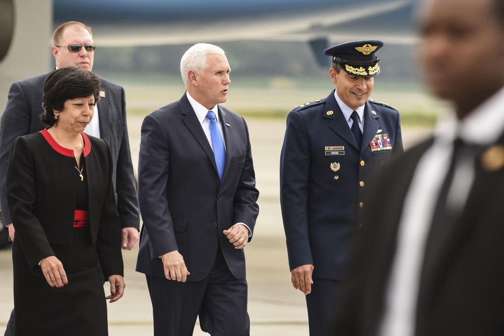 US Vice President Mike Pence (C) is welcomed by Colombia's Foreign Affairs Vice Minister Luz Stella Jara (L) and Colombia's Air Force General Luis Carlos Cordoba, upon arrival in Bogota, on February 25, 2019.  AFP / JOAQUIN SARMIENTO