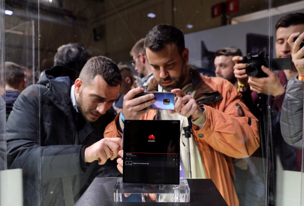 People take pictures of the new Mate X smartphone, ahead of the Mobile World Congress (MWC 19) in Barcelona, Spain, February 24, 2019. Reuters/Sergio Perez
