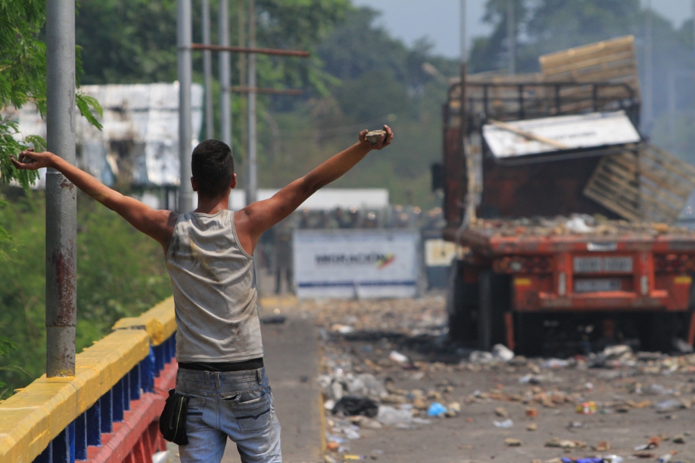 A protester holds a rock in his hand at the Francisco de Paula Santander Bridge in Tachira, Venezuela on February 24, 2019.  Daniel Salgar Antolinez - Anadolu 