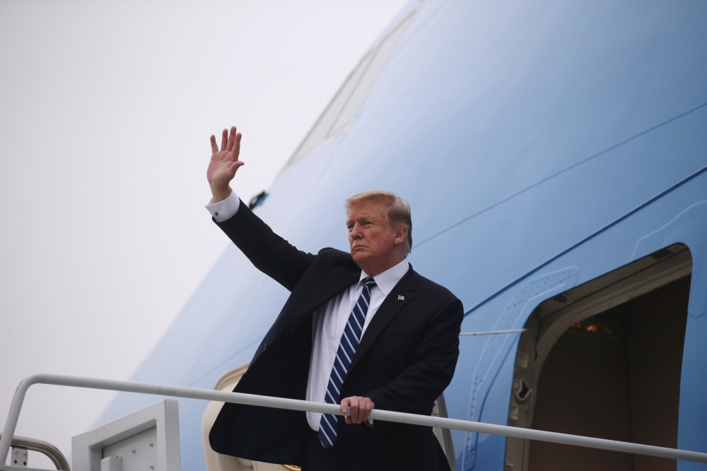US President Donald Trump boards Air Force One after his summit with North Korean leader Kim Jong Un, at Noi Bai International Airport in Hanoi, Vietnam, February 28, 2019. REUTERS/Leah Millis