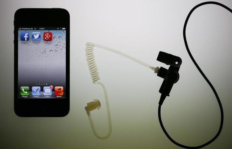 The application icons of Facebook, Twitter and Google are displayed on an iPhone next to an earphone set in this illustration photo taken in Berlin, June 17, 2013. Reuters/Pawel Kopczynski