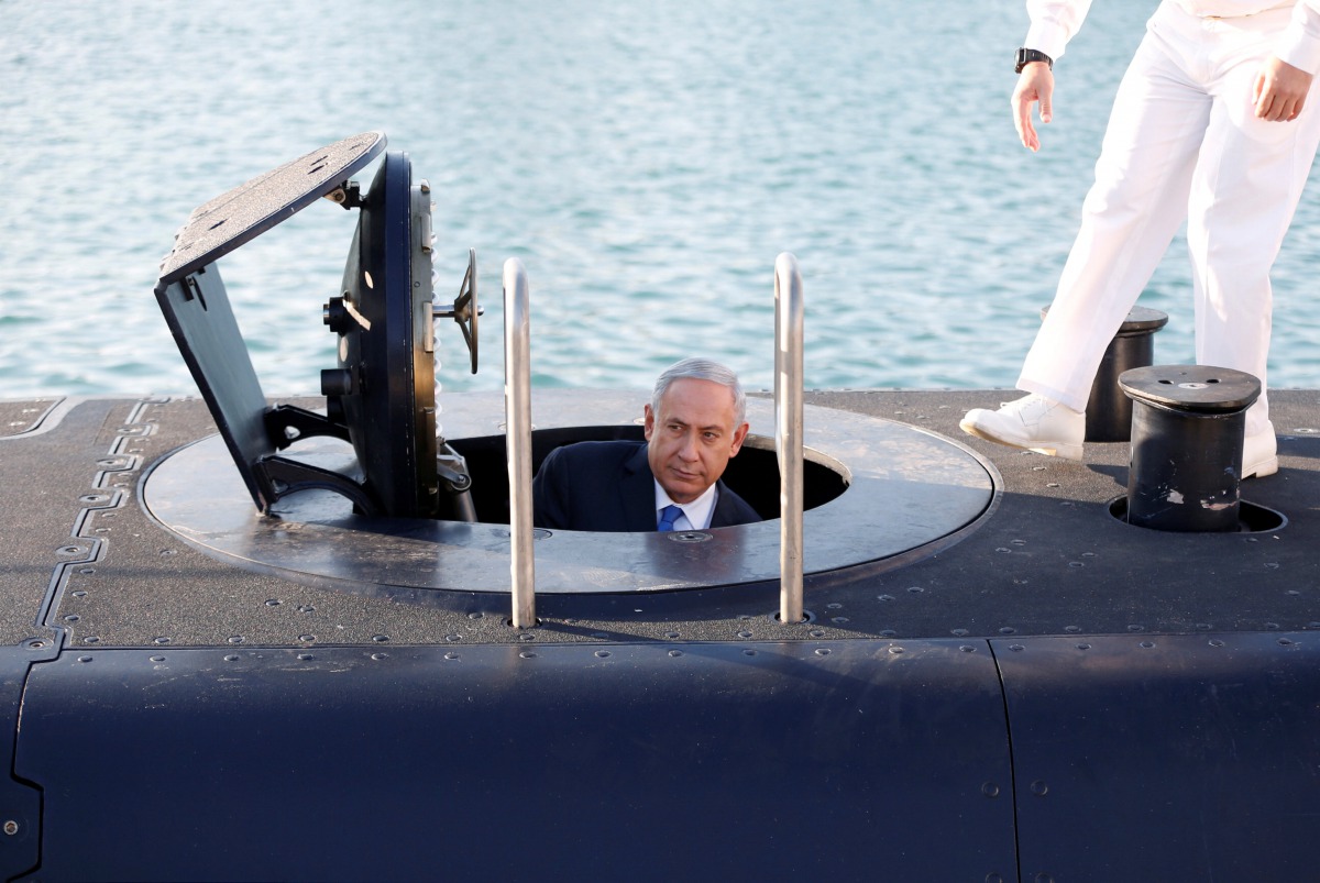 Israeli Prime Minister Benjamin Netanyahu climbs out after a visit inside the Rahav the fifth submarine in the fleet after it arrived in the Haifa port, January 12, 2016. Reuters/Baz Ratner