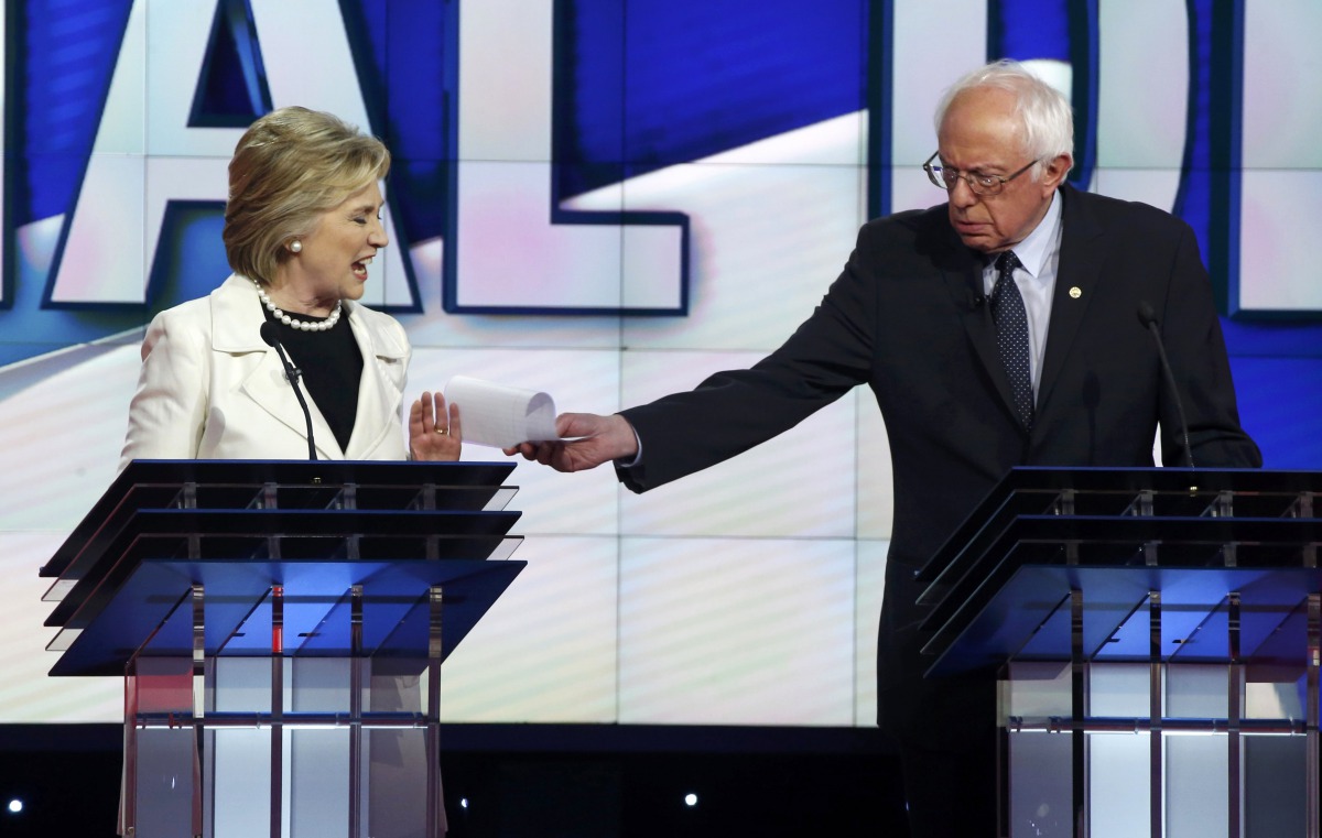 Hillary Clinton reacts as rival Bernie Sanders tries to hand her a piece of paper during a Democratic debate hosted by CNN and New York One at the Brooklyn Navy Yard, April 14, 2016. Reuters / Lucas Jackson