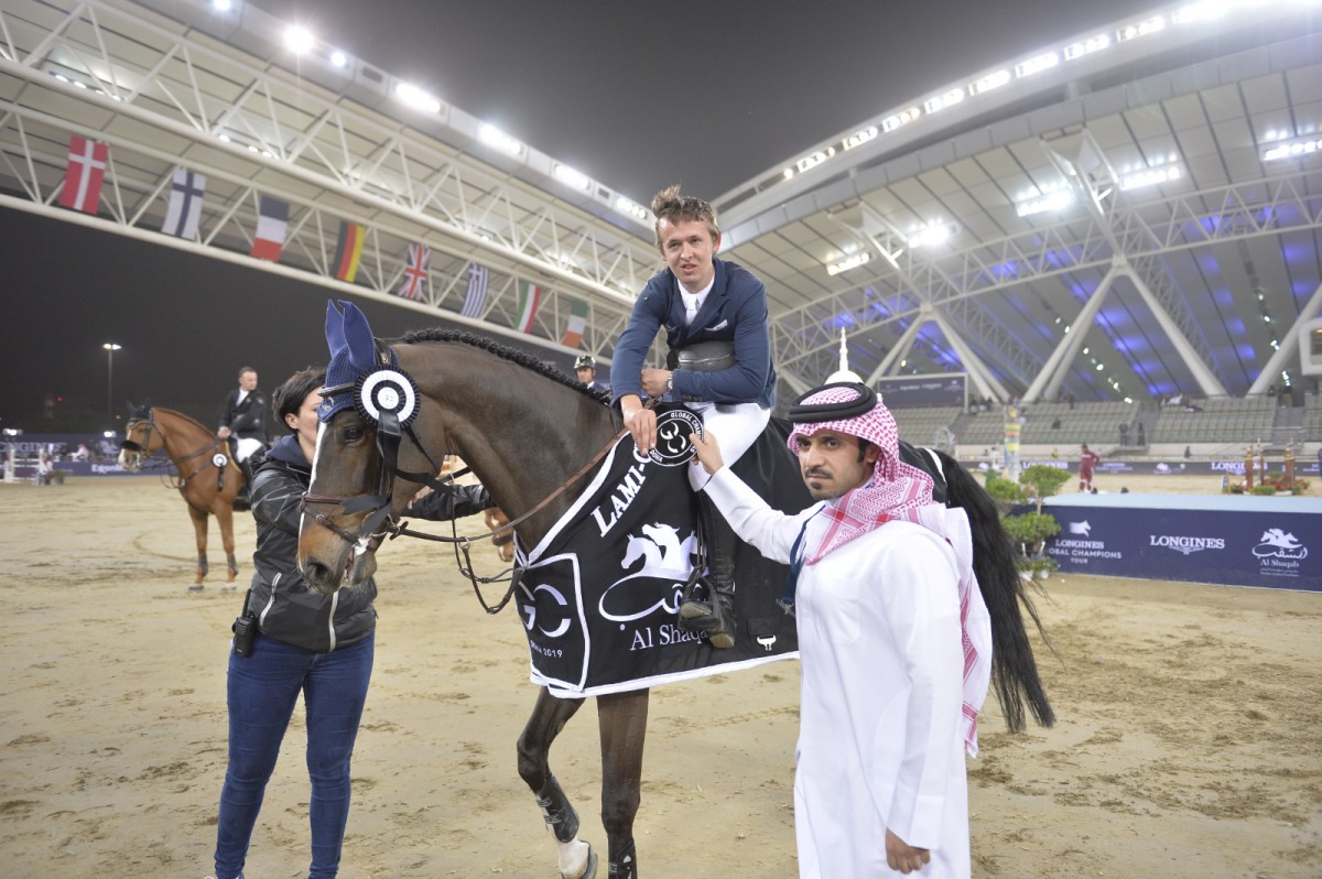 Secretary-General of Qatar Equestrian Federation (QEF), Badr Al Darwish, presenting the winner's award to Bertram Allen.  