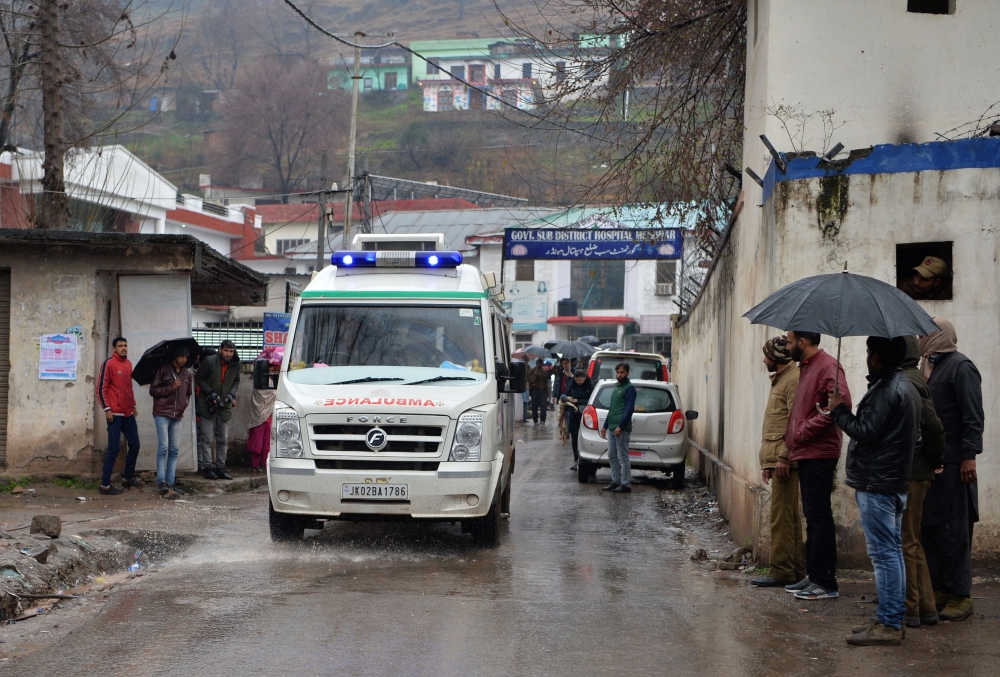 An injured man is transported in an ambulance in the Indian Kashmir frontier town of Mendhar on March 2, 2019, after being wounded in his home when it was struck by a mortar shell that his family said was fired by Pakistan troops along the Line of Control