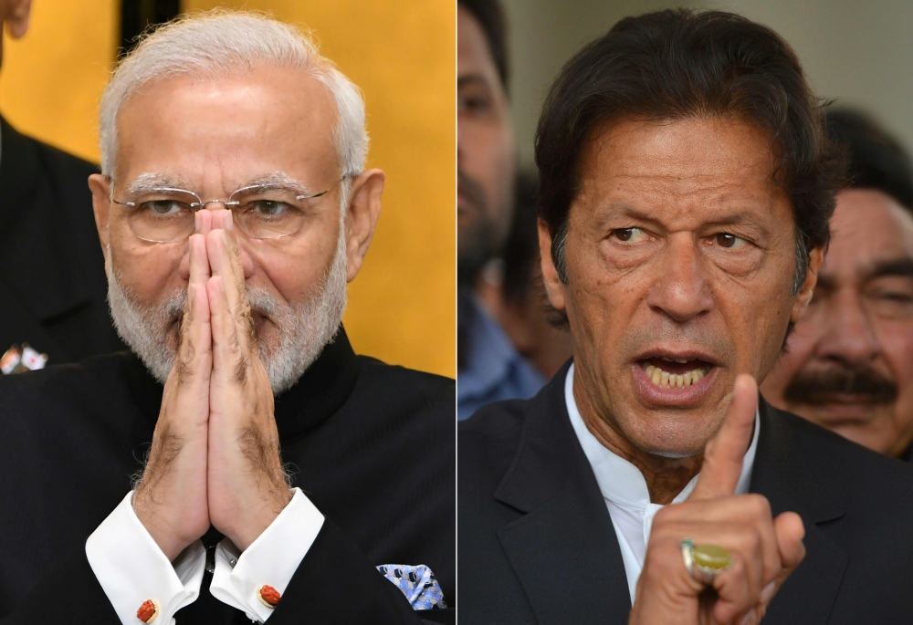 This combination of file pictures created on March 4, 2019 shows (L) India's Prime Minister Narendra Modi on an official visit to Tokyo on October 29, 2018, and (R) Pakistan's Imran Khan, chief of the Pakistan Tehreek-i-Insaf (PTI) political party, speaki