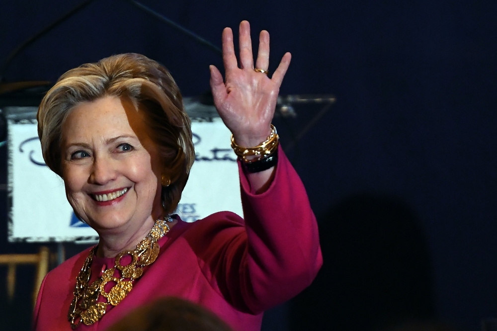 (FILES) In this file photo taken on February 16, 2017 former US Secretary of State and Democratic presidential nominee Hillary Clinton waves as she arrives to unveil US postal service issued Oscar de la Renta Forever stamp during a ceremony in New York. A