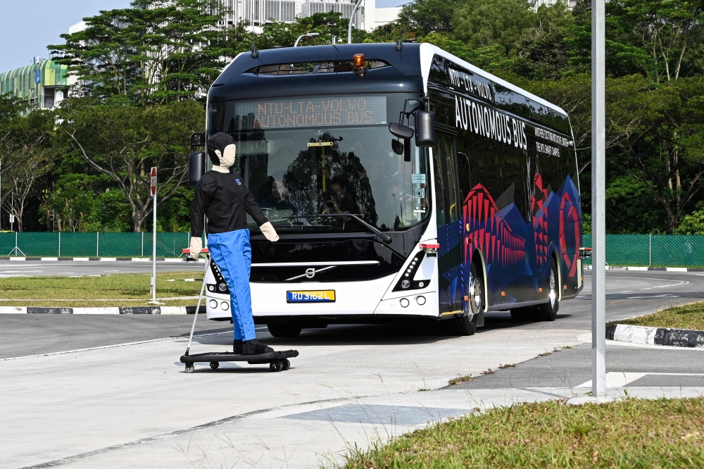A Volvo AB 7300 electric autonomous bus drives on the track of Centre of Excellence for Testing & Research of Autonomous Vehicles after being unveiled in Singapore on March 5, 2019. AFP / Roslan Rahman 