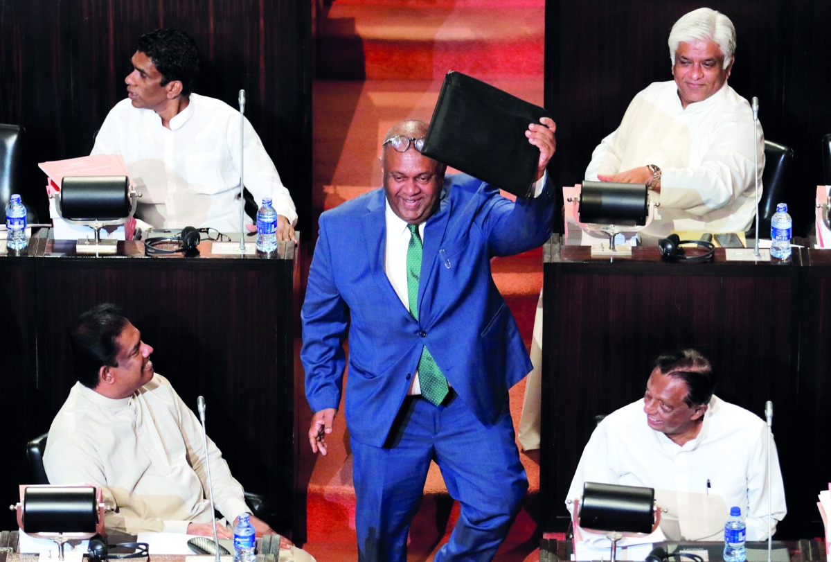 Sri Lankan Finance Minister Mangala Samaraweera shows a briefcase containg the 2019 budget proposals as he arrives at parliament in Colombo, March 5, 2019. Reuters/Dinuka Liyanawatte