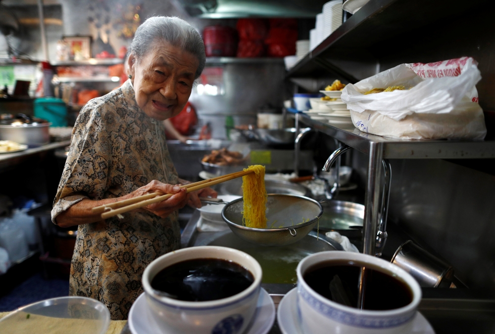 Hawker Leong Yuet Meng, 90, of Nam Seng Noodle House, poses as she cooks noodles at her shop in Singapore February 22, 2019. Picture taken February 22, 2019. REUTERS/Edgar Su