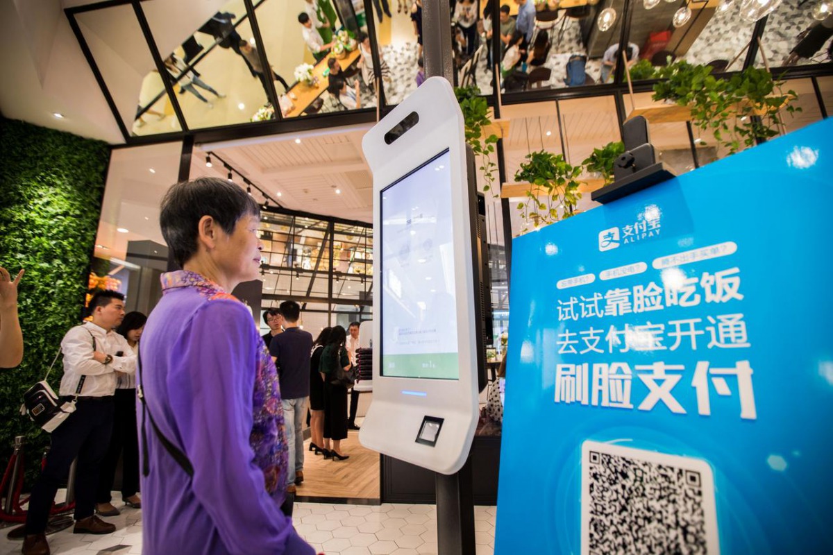 A customer tries Alipay's facial recognition payment solution 