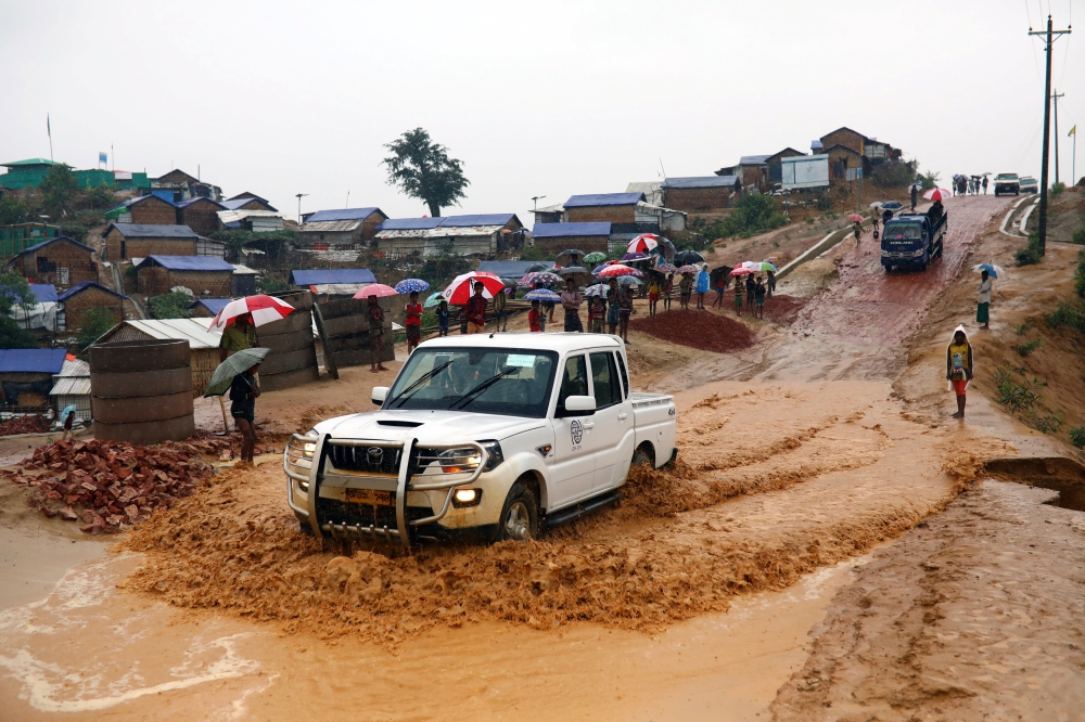 A car moves on the road through the rainwater in the Balukhali refugee camp in Cox's Bazar, Bangladesh, March 6, 2019. Reuters/Mohammad Ponir Hossain