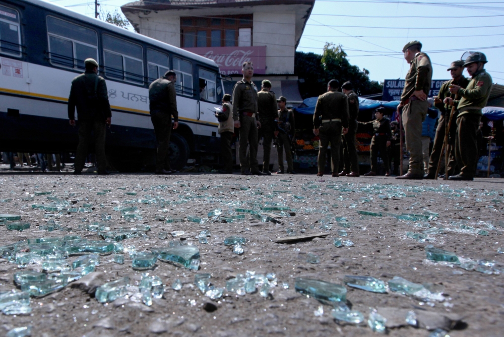 Indian police inspect the site of a grenade blast at a bus station in Jammu on March 7, 2019. Eighteen people were injured on March 7 when a grenade exploded at a bus stop in the Indian city of Jammu, part of the restive state of Jammu and Kashmir, police