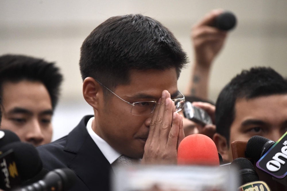 Thai Raksa Chart party leader Preechaphol Pongpanich gestures to journalists after the Constitutional Court ruling to dissolve the party in Bangkok on March 7, 2019. AFP / Lillian SUWANRUMPHA
