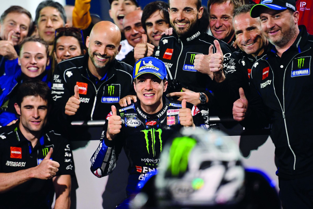 Monster Energy Yamaha MotoGP’s Maverick Vinales of Spain (centre), who clocked the best time yesterday, poses with his team at the end of the qualification session at the Losail International Circuit.