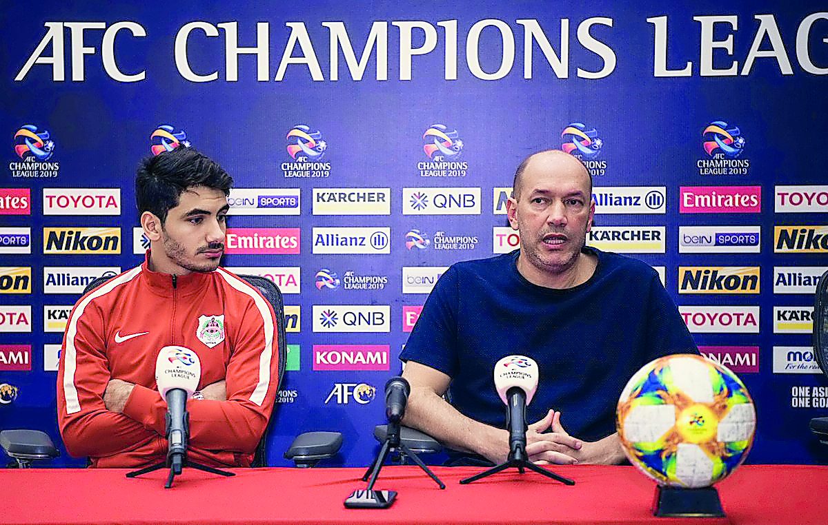 Al Rayyan coach Gilson Souza (right) speaks during a press conference as defender Mohamed Al Aaeldin looks on.   
