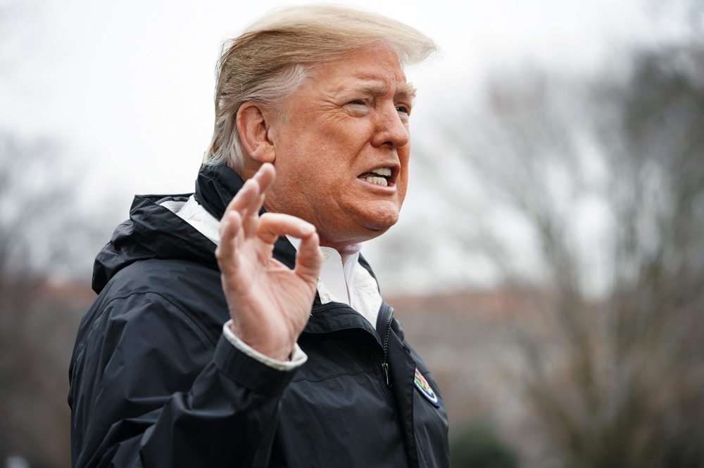 FILE PHOTO: US President Donald Trump speaks to the press before boarding Marine One at the White House in Washington, DC.  AFP / MANDEL NGAN