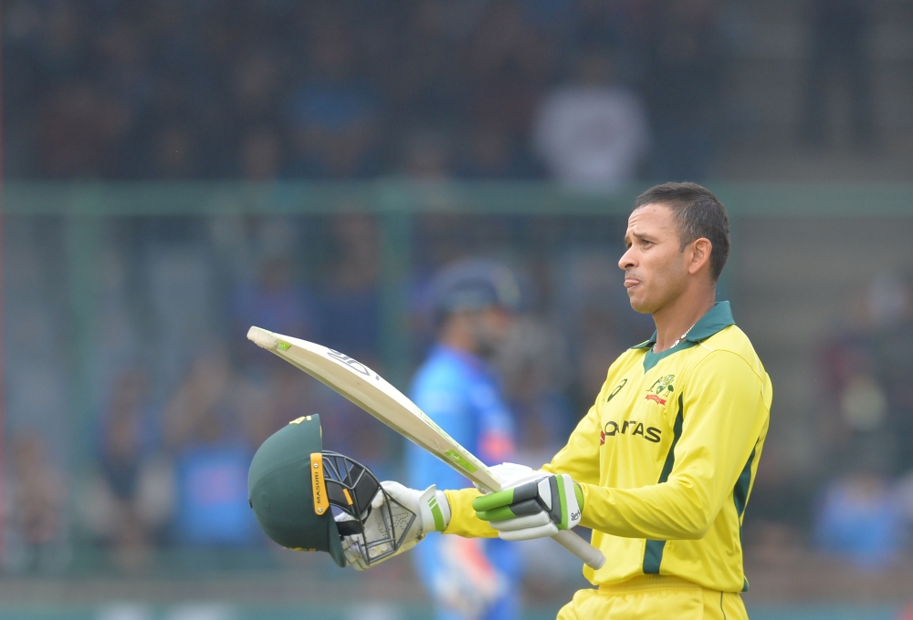 Australia's cricketer Usman Khawaja celebrates after achieving his century (100 runs) during the fifth one-day international (ODI)cricket match between India and Australia at the Feroz Shah Kotla Stadium in New Delhi on March 13, 2019. (AFP / Sajjad HUSSA