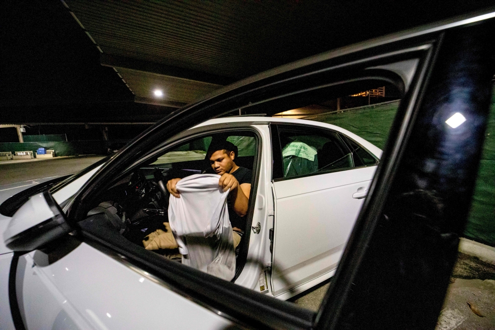 Cameron Jones, 26, a Marine Corps veteran who served in Afghanistan, prepares to sleep in a Safe Parking LA location near the Veteran's Affairs Los Angeles Healthcare Center in Los Angeles, California, February 11, 2019.  AFP / Kyle Grillot