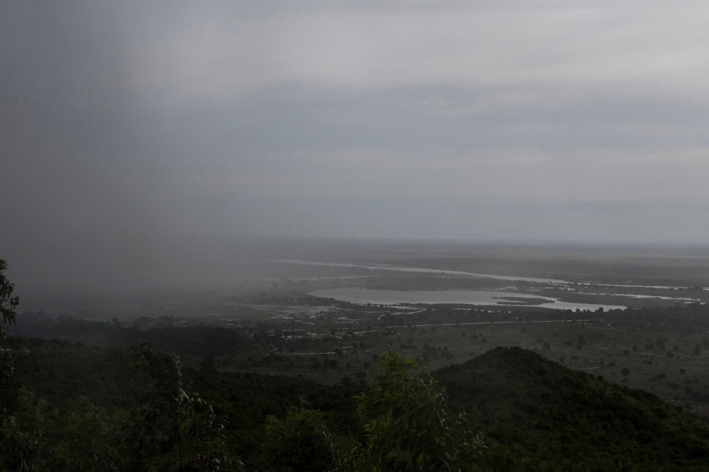 Rain, which is believed to be the beginning of Tropical cyclone Idai coming from central Mozambique, falls in the flooded districts of Chikwawaa and Nsanje in southern Malawi, on March 15, 2019. AFP / AMOS GUMULIRA