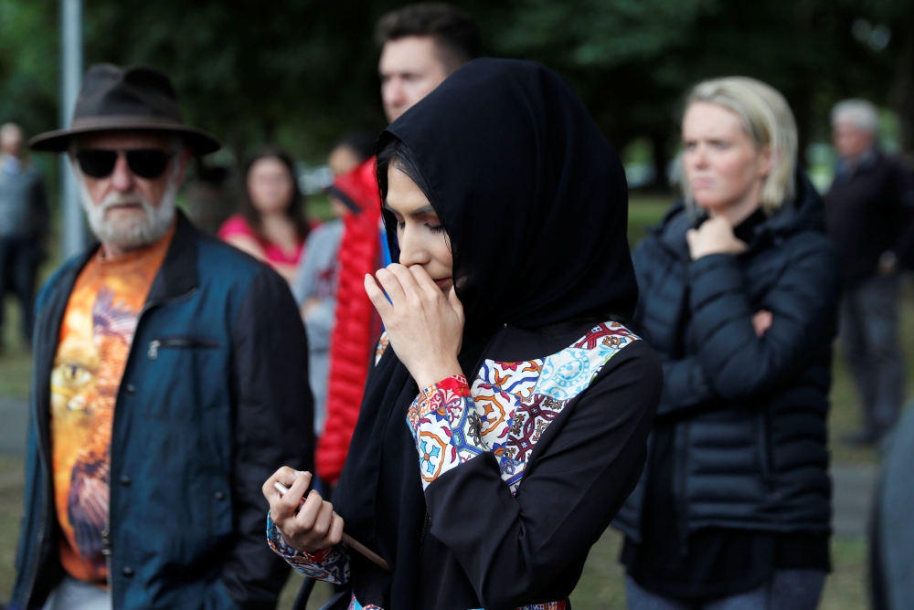 A woman from Afghanistan reacts near Masjid Al Noor mosque in Christchurch, New Zealand, March 17, 2019. REUTERS/Jorge Silva