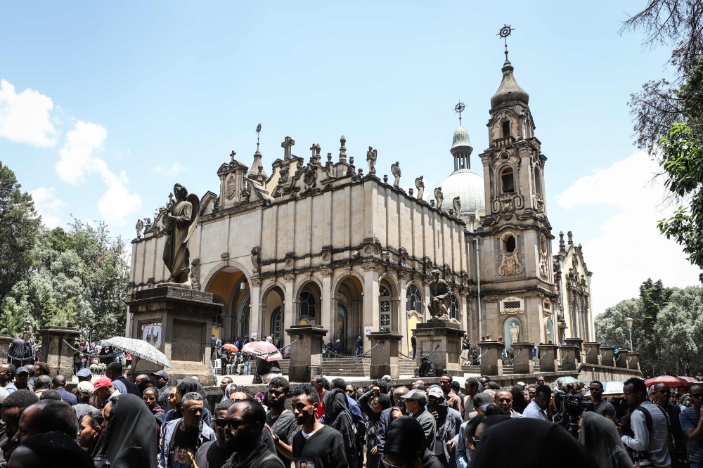Mourners of victims of the crashed accident of Ethiopian Airlines react during the mass funeral at Holy Trinity Cathedral in Addis Ababa, Ethiopia, on March 17, 2019. / AFP / Michael TEWELDE