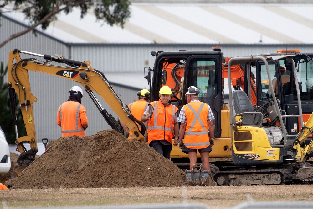 Workers dig grave sites at a cemetery in Christchurch on March 17, 2019 two days after a shooting incident at two mosques in the city.  AFP / Marty Melville 