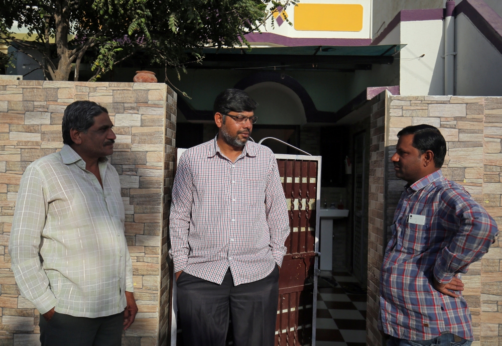 Altaf Khokhar, son of Mahebubbhai Khokhar who was killed in Friday's mosque attacks in New Zealand, speaks with his neighbours outside his home in Sunrendranagar in the western state of Gujarat, India, March 17, 2019. Reuters/Amit Dave
