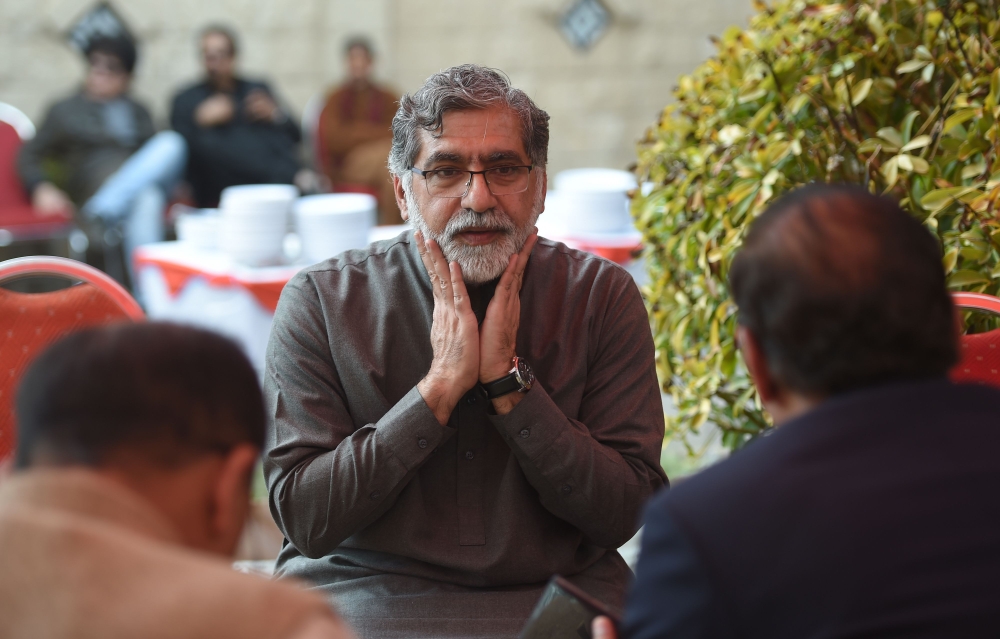 Rizwan Rashid (C), elder brother of Pakistani national Naeem Rashid, who was killed in the attacks to the Christchurch mosques in New Zealand, prays for his brother at Naeem house in Abbottabad on March 17, 2019.  AFP / Farooq Naeem 