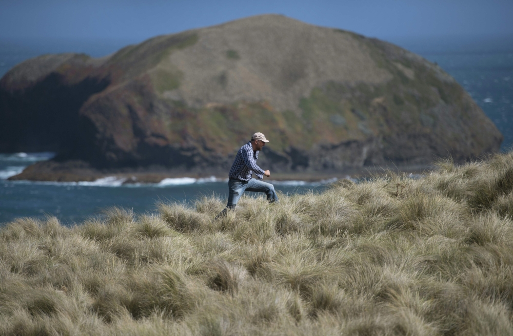 This photo taken on February 24, 2019 shows Mike Buckby from the Cape Grim Water Company walking in Cape Grim, Tasmania. Andrew BEATTY / AFP / William WEST