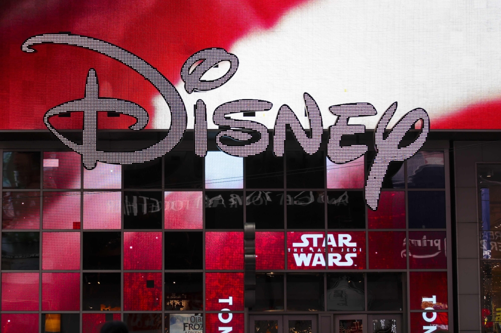 (FILES) In this file photo taken on December 14, 2017 the Disney logo is displayed outside the Disney Store in Times Square in New York City. AFP / GETTY IMAGES NORTH AMERICA / Drew Angerer