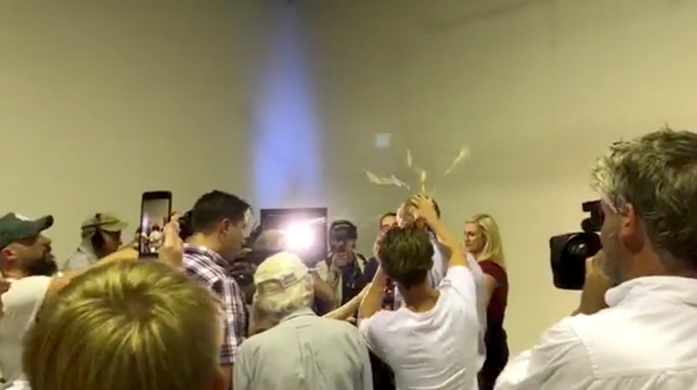 Australian Senator Fraser Anning has an egg smashed on his head while talking to the media in Victoria, Australia March 16, 2019 in this still image taken from a video obtained from social media. THE UNSHACKLED/via REUTERS